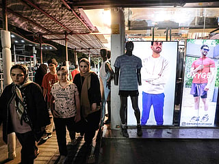 Iranians walk along a shopping street in southern Tehran. 