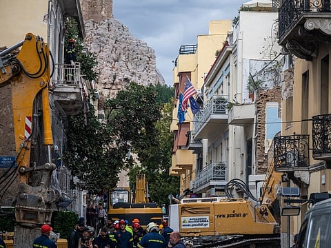Emergency personnel work after an old building partially collapsed following an explosion in the Plaka area of central Athens on September 26, 2026.