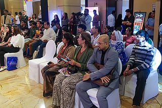 Students and parents listening to educators during a panel discussion at Edufair 