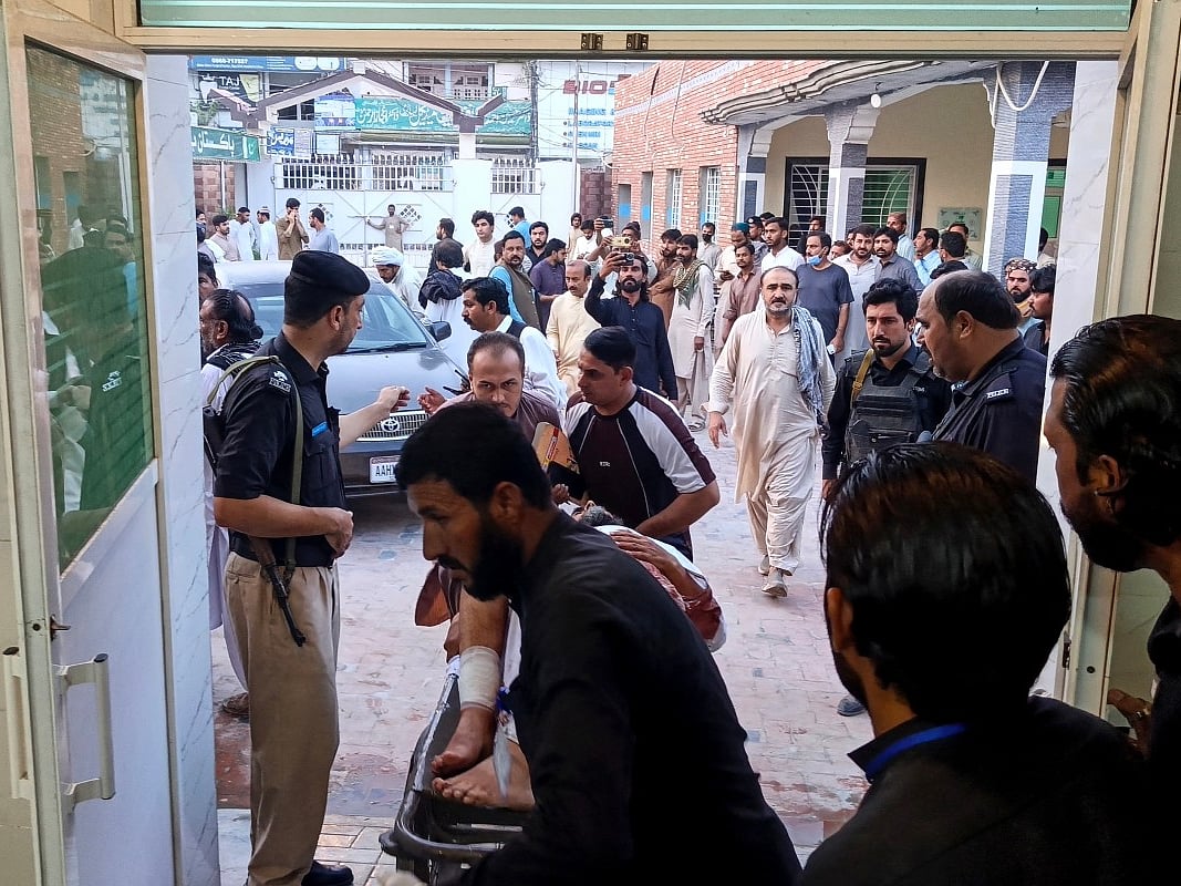 People carry an injured blast victim inside a hospital at Dera Ismail Khan in Pakistan's Khyber Pakhtunkhwa province on September 26, 2026.