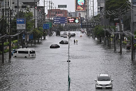 Vehicles are seen stranded in flood waters along Phetchaburi Road in Bangkok on September 26, 2026.