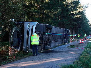 Emergency services and firefighters work at the site of a bus accident near Buchloe-Ost, southern Germany where the coach had overturned on the A96 motorway.