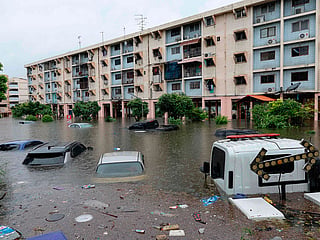 Flood waters submerge cars next to residential buildings after heavy rain in Bangkok.