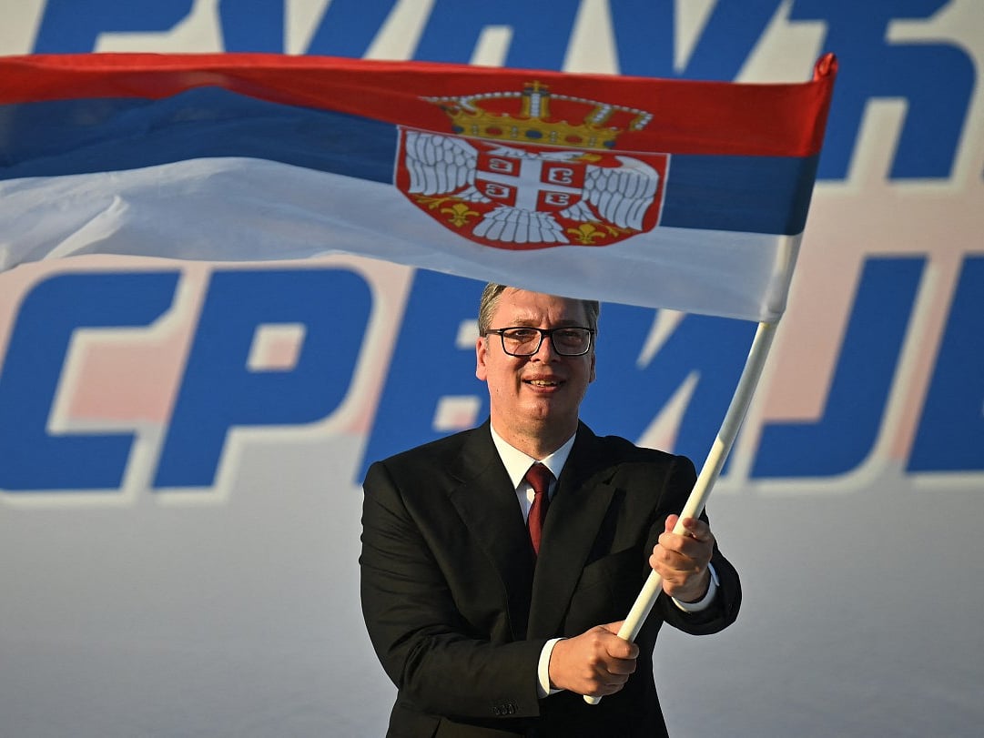 Serbia's President Aleksandar Vucic waves a Serbian flag during a rally in Belgrade on June 27, 2026.