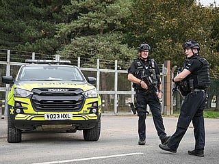 Armed police stand guard at an entrance to RAF Fairford base in Fairford, south-west England on September 27, 2026, as UK counter-terrorism police investigate an incident near the base in the village of Whelford.