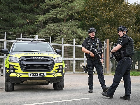 Armed police man a roadblock while posted at an entrance to RAF Fairford base in Fairford, south-west England on September 27, 2026, as UK counter-terrorism police investigate an incident near the base in the village of Whelford.