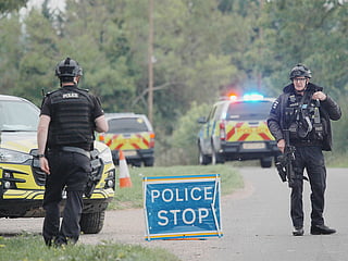 Police stand at a road block on the road to RAF Fairford after an incident, in Whelford, England, Sunday, Sept. 27, 2026 .(Ben Birchall/PA via AP)