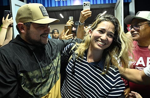 Opposition figure Claudia Macero is welcomed by relatives after arriving at the Simon Bolivar international airport in Maiquetia, Venezuela on September 27, 2026.