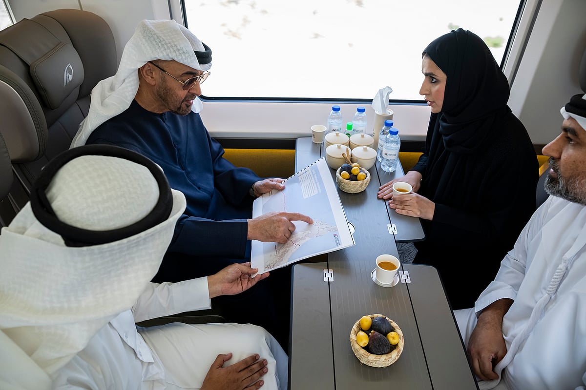 UAE President Sheikh Mohamed bin Zayed Al Nahyan, views a map while travelling by train from Abu Dhabi to Dubai to attend the inauguration of the Etihad Rail station in Dubai.