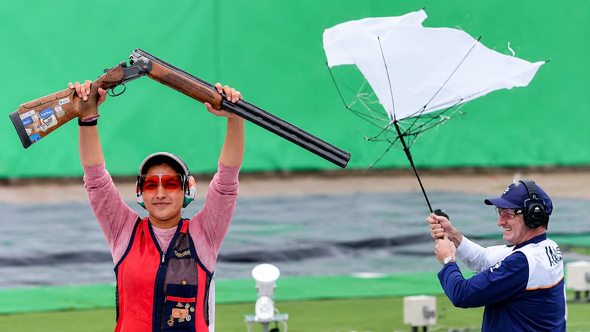 India coach Peter Wilson celebrates Neeru Dhanda's historic Asian Games trap gold, breaking his umbrella in excitement.