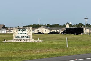 FILE - Law enforcement vehicles sit parked outside the Florida state prison in Starke, Fla., on Tuesday, July 28, 2026. (AP Photo/David Fischer, file)