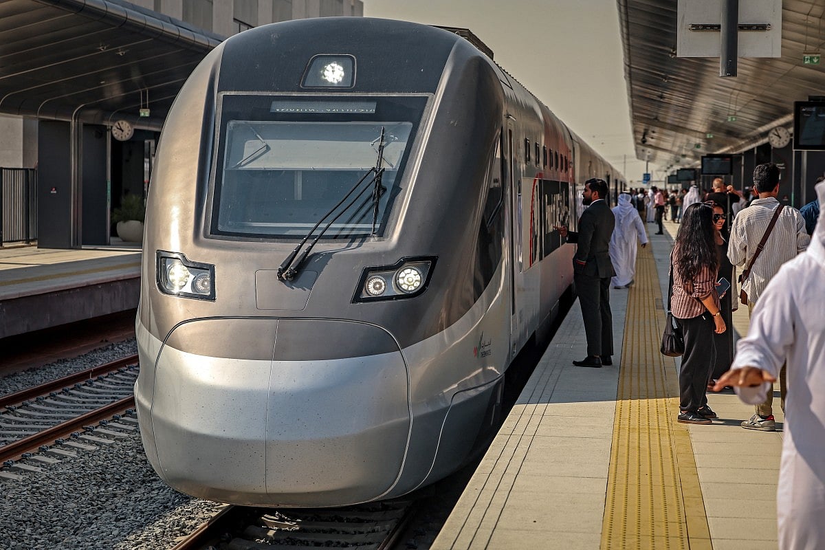 People board an Etihad Rail train at Dubai's Yalayis station on September 29, 2026, during the inaugural passenger service connecting from Abu Dhabi's Mohamed Bin Zayed City station to Dubai.