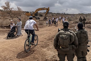 Israeli families march along the road between Ganim and Kadim settlements on the outskirts of Israeli-occupied West Bank city of Jenin on September 30, 2026.
