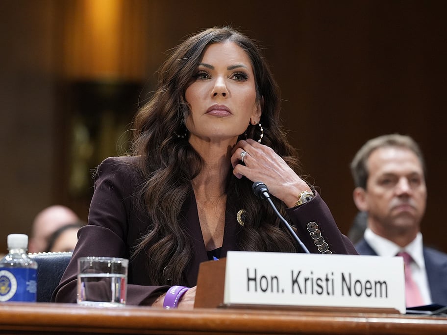 Then Homeland Security Secretary Kristi Noem, center, with her husband Bryon Noem, right, seated behind her, appears for an oversight hearing before the Senate Judiciary Committee, at the Capitol in Washington, March 3, 2026.  