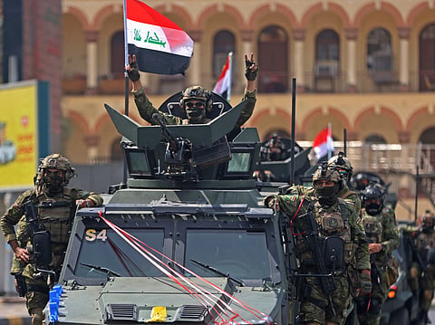 A member of the Iraqi security forces, flashes the victory sign during a military parade marking the withdrawal of the US-led coalition from Iraq, in Baghdad on September 30, 2026.