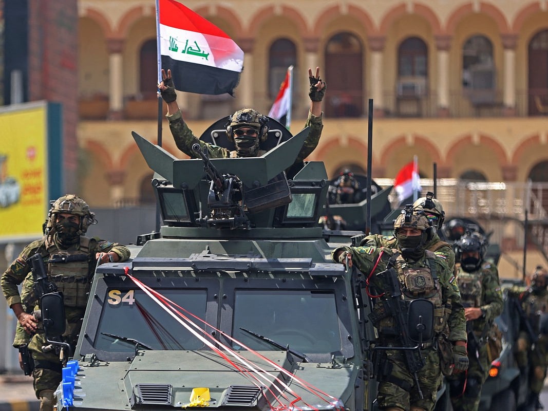 A member of the Iraqi security forces, flashes the victory sign during a military parade marking the withdrawal of the US-led coalition from Iraq, in Baghdad on September 30, 2026.