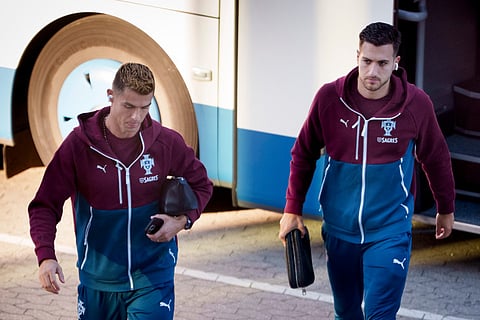 Portugal's forward #07 Cristiano Ronaldo (L) and Portugal's defender #02 Diogo Dalot arrive for a training session at Parken stadium in Copenhagen, Denmark, on September 30, 2026, on the eve of their Nations League Group A4 match against Denmark.