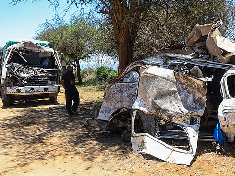 A man views the wreckage of a 14-seater minibus that was involved in an accident killing all the passengers, in the Salama area, Makueni County, Eastern Kenya, Saturday, October 3, 2026. 