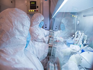 This undated photo released by the Irkutsk Anti-Plague Research Institute of Siberia and Far East, shows the institute workers in a lab. 
