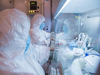 This undated photo released by the Irkutsk Anti-Plague Research Institute of Siberia and Far East, shows the institute workers in a lab. 