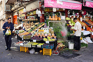 Iranians shop at a street market in Tehran on September 23. The falling rial and rising living costs have eroded the purchasing power of salaries as US economic pressure intensifies.