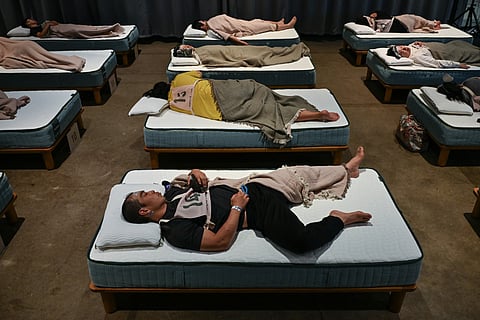 Attendees take part in a sleep competition organized by a mattress brand in Tokyo.