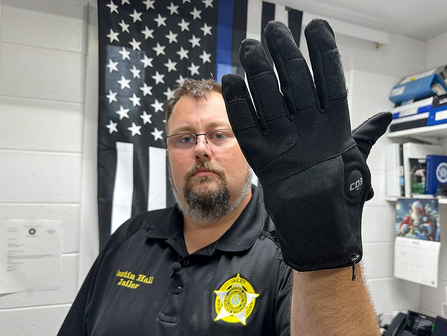 Nelson County, Ky., jailer Justin Hall shows an electric shock glove that is used at his facility, Aug. 13, 2026, in Bardstown, Ky. 