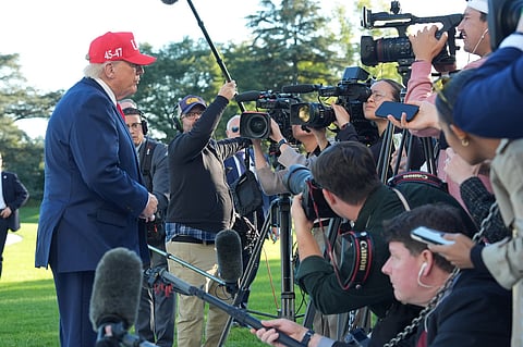 President Donald Trump speaks with reporters after arriving on Marine One from the South Lawn of the White House, Tuesday, Oct. 6, 2026, in Washington.