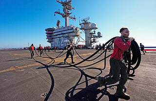 Crew members prepare the USS Abraham Lincoln (CVN 72) for return on Wednesday, Oct. 7, 2026, to her home port Naval Air Station North Island in San Diego, California.
