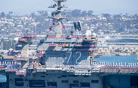 The USS Abraham Lincoln Nimitz-class aircraft carrier approaches its homeport at Naval Air Station North Island on return from its historic 10-month deployment on October 8, 2026 as seen from the Port of San Diego in San Diego, California.