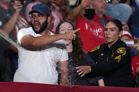 Police remove protesters as President Donald Trump speaks at a campaign rally at the Freeman Coliseum in San Antonio, Wednesday, Oct. 7, 2026. (AP Photo/Eric Gay)