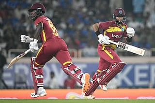 West Indies captain Shai Hope (R) and teammate Sherfane Rutherford (L) run between the wickets during the second T20I against India and West Indies at the JSCA International Stadium Complex in Ranchi on October 9, 2026.