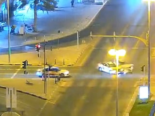 The footage shows a motorist driving through a red light before colliding head-on with another vehicle. 
