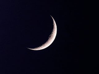 The waxing crescent moon and the planet Venus are pictured after sunset over Doha on September 14, 2026.