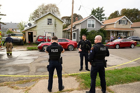 Police stand outside the home at 722 Perry Street where 8 people were killed in an apparent domestic dispute on October 10, 2026 in Erie, Pennsylvania.