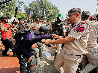 Police detain protesters during a demonstration demanding the resignation of Chief Election Commissioner Gyanesh Kumar in New Delhi, India, Saturday, Oct. 10, 2026.