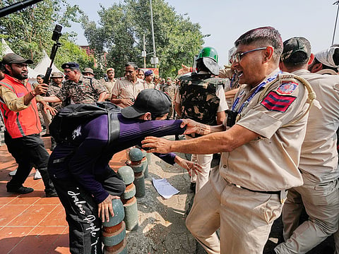 Police detain protesters during a demonstration demanding the resignation of Chief Election Commissioner Gyanesh Kumar in New Delhi, India, Saturday, Oct. 10, 2026.