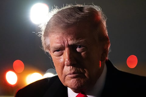 President Donald Trump speaks with reporters as he arrives on Air Force One, Saturday, Oct. 10, 2026, at Joint Base Andrews, Md. (AP Photo/Alex Brandon)