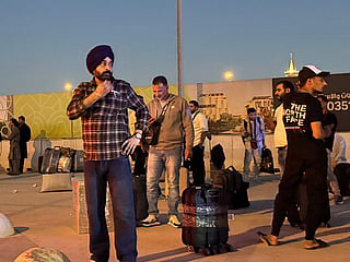 People gather outside a metro station on the road to King Khalid International Airport in Riyadh, Saudi Arabia.