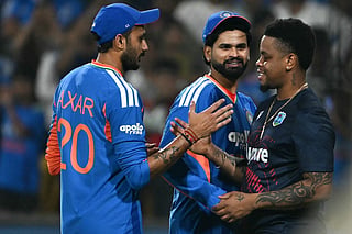 India's captain Shreyas Iyer (C) and teammate Axar Patel (L) are congratulated by West Indies' Shimron Hetmyer (R) after winning the third T20 international cricket match between India and West Indies at the Holkar Cricket Stadium in Indore on October 11, 2026.
