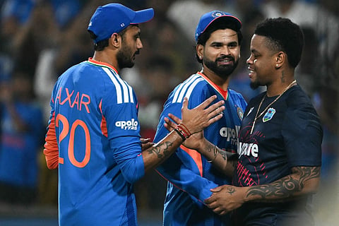 India's captain Shreyas Iyer (C) and teammate Axar Patel (L) are congratulated by West Indies' Shimron Hetmyer (R) after winning the third T20 international cricket match between India and West Indies at the Holkar Cricket Stadium in Indore on October 11, 2026.