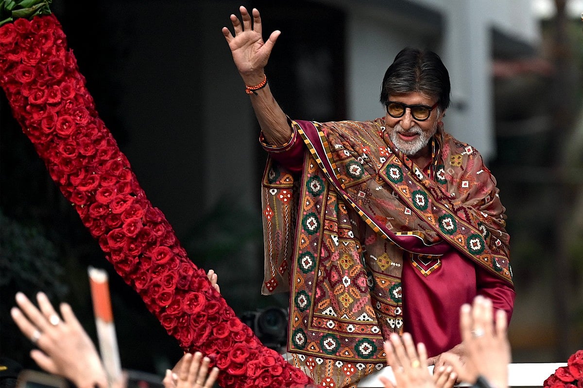 Bollywood actor Amitabh Bachchan gestures to fans gathered to celebrate his 84th birthday outside his residence in Mumbai on October 11, 2026.