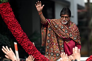 Bollywood actor Amitabh Bachchan gestures to fans gathered to celebrate his 84th birthday outside his residence in Mumbai on October 11, 2026.