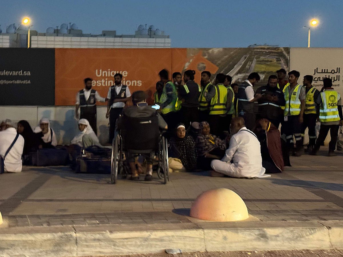 People gather outside a metro station on the road to King Khalid International Airport in Riyadh, Saudi Arabia.