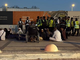 People gather outside a metro station on the road to King Khalid International Airport in Riyadh, Saudi Arabia.