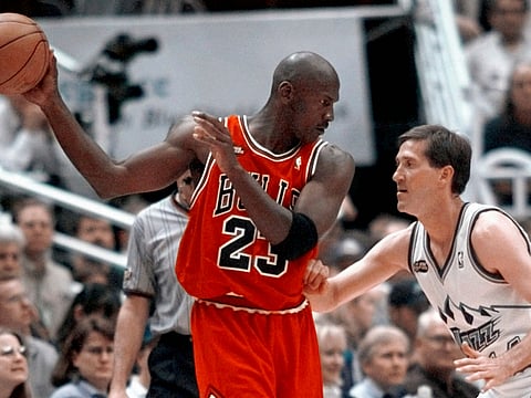 Chicago Bulls' Michael Jordan pulls the ball out of reach of Utah Jazz guard Jeff Hornacek during third quarter action in Game 2 of the NBA Finals in Salt Lake City, June 5, 1998. 
