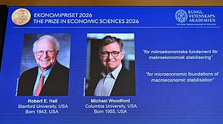 US macroeconomists Robert E Hall and Michael Woodford are seen on a screen as they are announced as the laureates of the 2026 Sveriges Riksbank Prize in Economic Sciences in Memory of Alfred Nobel at the Royal Swedish Academy of Sciences in Stockholm on October 12, 2026.