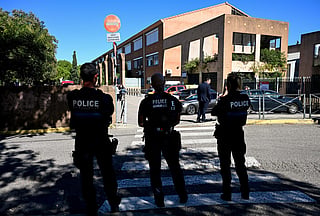 French municipal Police officers patrol outside the Joseph-Lakanal middle school after a headmaster was shot and wounded with a hunting rifle and a teenager was arrested in Aubagne, southern France on October 12, 2026.