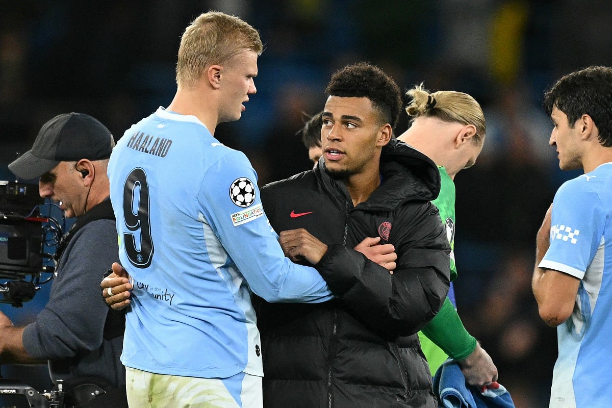 Manchester City's Norwegian striker #09 Erling Haaland (L) and Paris Saint-Germain's French midfielder #14 Desire Doue (C) chat on the pitch after the UEFA league-phase football match between Manchester City and PSG at the Etihad Stadium in Manchester, northwest England, on October 14, 2026.
