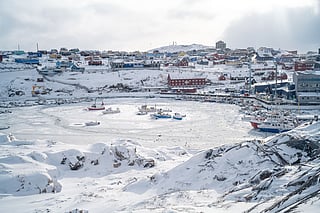 This photograph, taken from the Hotel Arctic, shows the port of Ilulissat trapped in ice, in Greenland, on March 19, 2026.